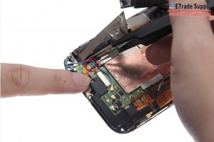 Peel off the Charging Port Flex Sticker and pry out the connector with the Tweezers