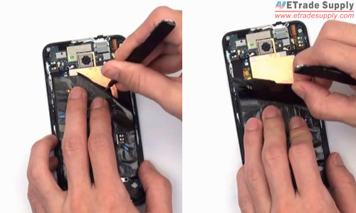 Gently peel off the paper covering on the HTC Droid DNA motherboard with the help of tweezers