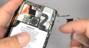 Lift up the plastic film to release the flex ribbon of the battery