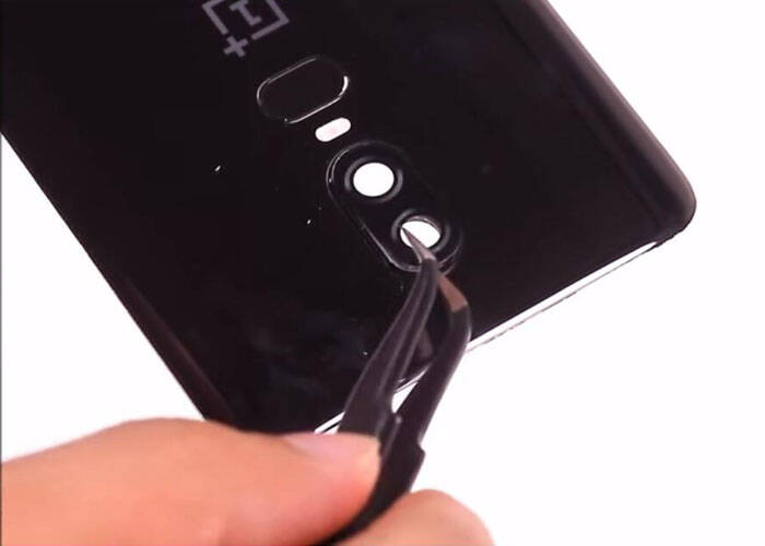 Place the new camera lens cover on the battery door