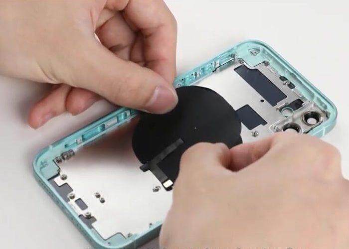 Install the wireless charging coil onto the iPhone 12