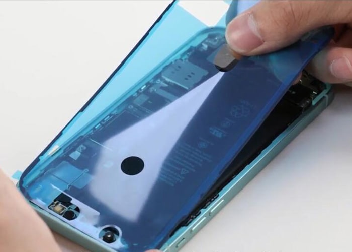 Apply the frame adhesive sticker on to the iPhone